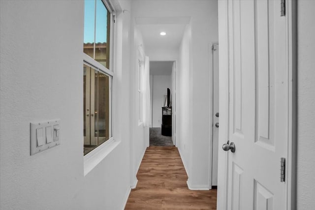 hall with hardwood / wood-style flooring