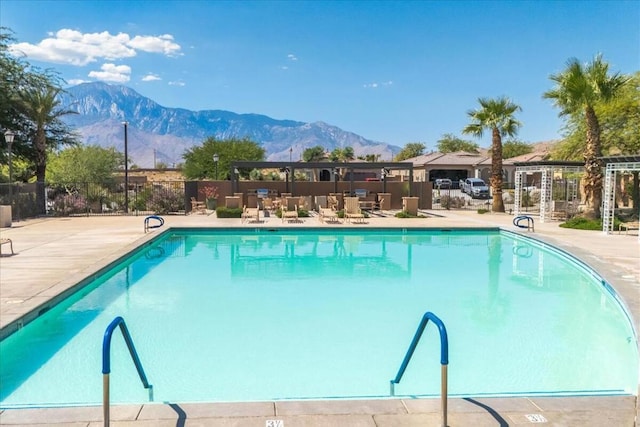 view of swimming pool featuring a mountain view and a patio area