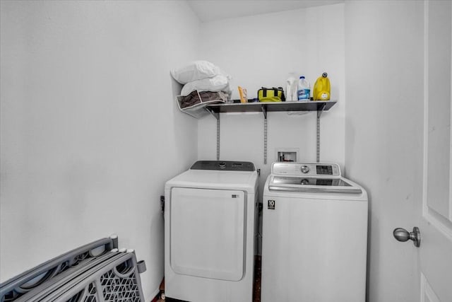 clothes washing area with washing machine and dryer