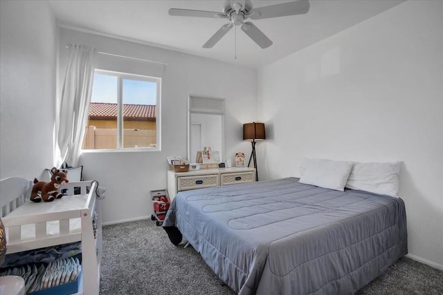 bedroom featuring ceiling fan and dark carpet