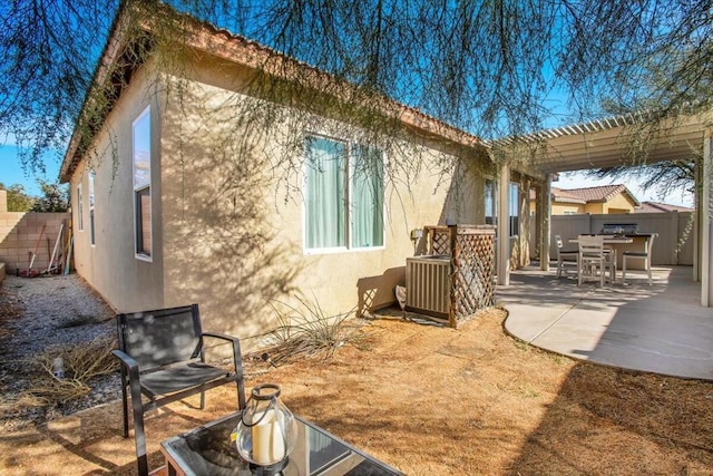 back of house featuring a pergola, central AC unit, and a patio