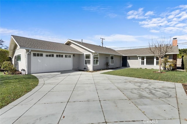 single story home featuring a garage and a front lawn