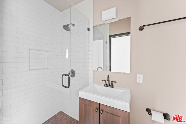 bathroom featuring an enclosed shower and vanity