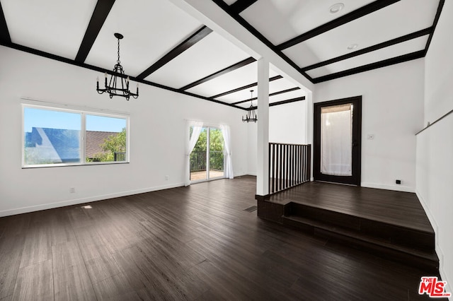 unfurnished living room featuring dark wood-type flooring, beamed ceiling, and a notable chandelier