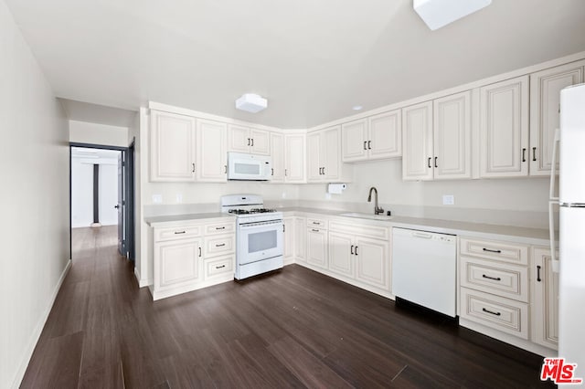 kitchen with white cabinetry, sink, white appliances, and dark hardwood / wood-style floors