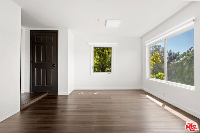 spare room with dark hardwood / wood-style floors