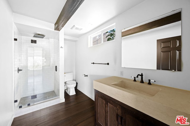 bathroom with toilet, wood-type flooring, an enclosed shower, beam ceiling, and vanity