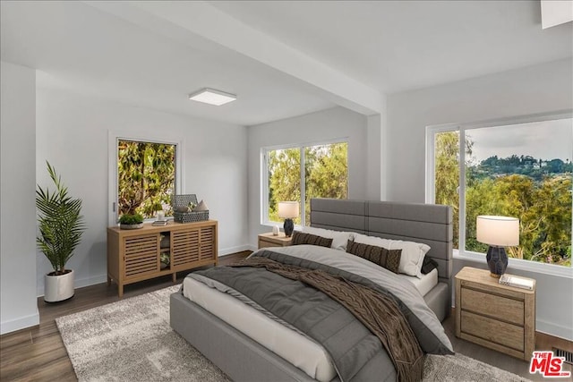 bedroom with dark wood-type flooring