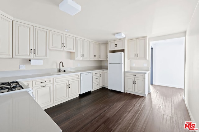 kitchen featuring white cabinetry and white appliances