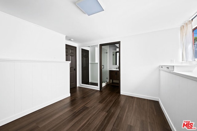 unfurnished room featuring dark hardwood / wood-style flooring