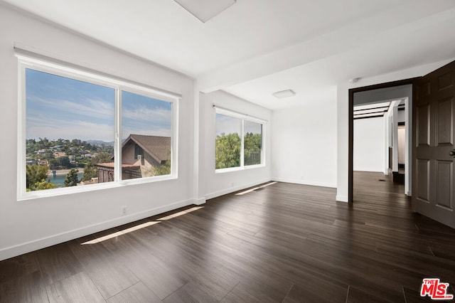 unfurnished room featuring dark hardwood / wood-style floors