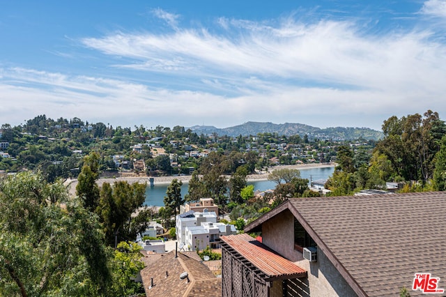 drone / aerial view featuring a water and mountain view