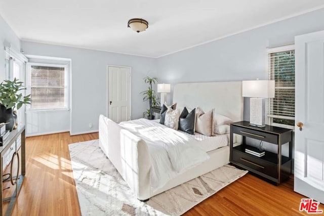 bedroom with light hardwood / wood-style floors