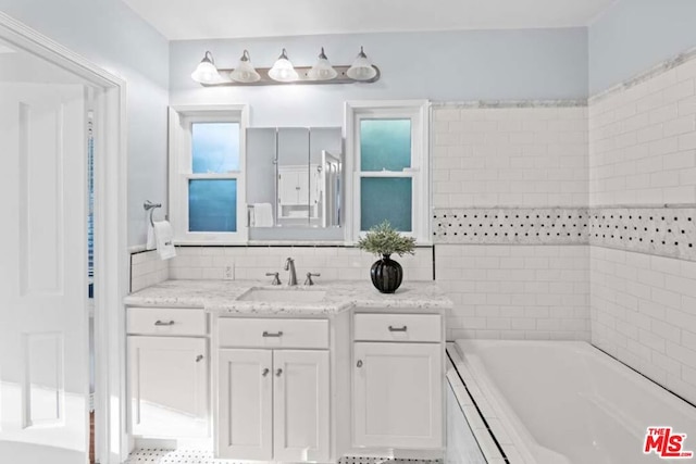 bathroom featuring a tub to relax in and vanity