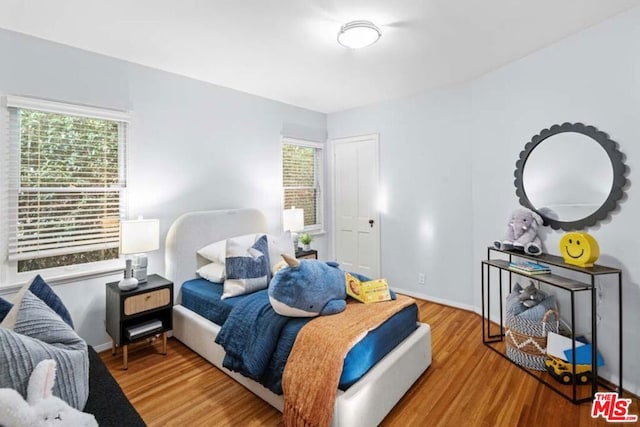 bedroom with light wood-type flooring