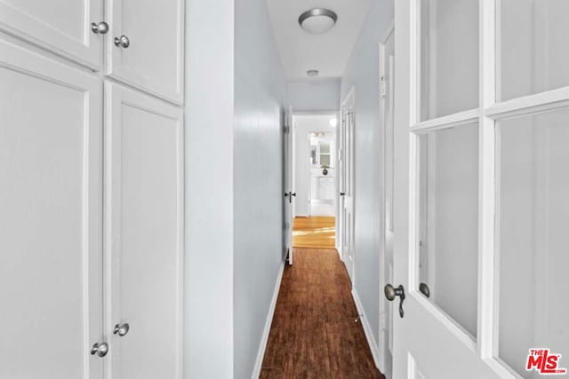 corridor featuring dark hardwood / wood-style flooring