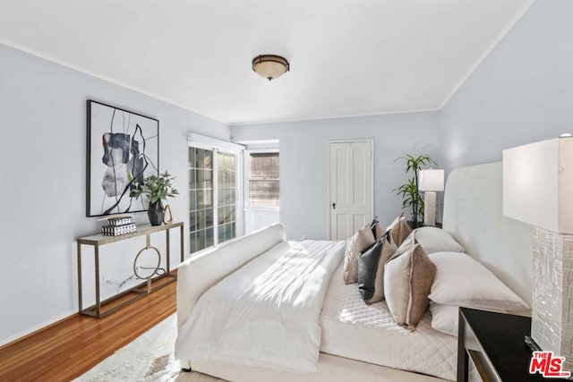 bedroom with hardwood / wood-style floors