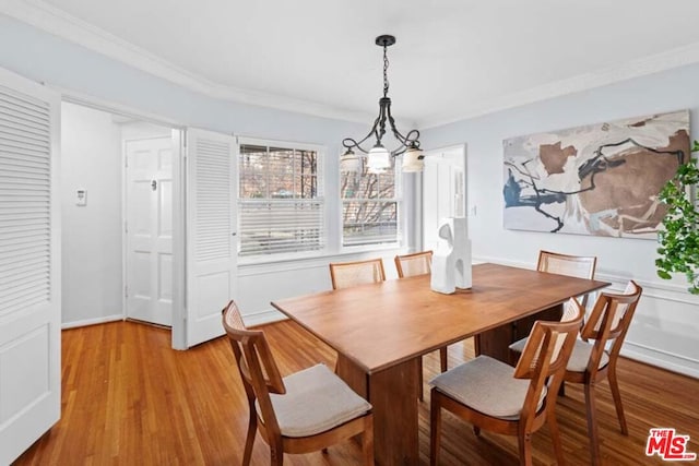 dining room featuring ornamental molding and light hardwood / wood-style floors