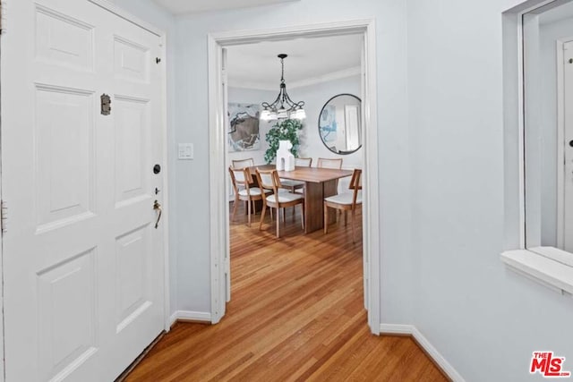 foyer with hardwood / wood-style flooring and a notable chandelier