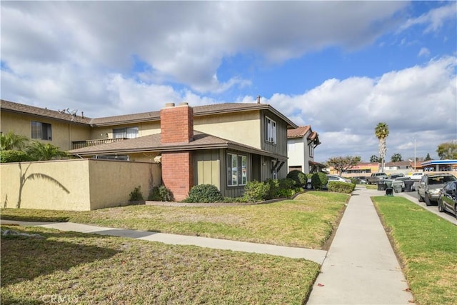 view of home's exterior with a lawn