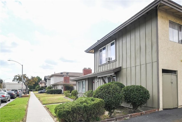 view of side of home with a yard