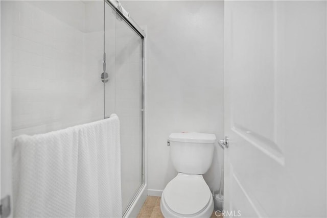 bathroom with walk in shower and toilet