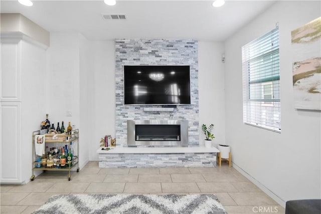 tiled living room with a fireplace