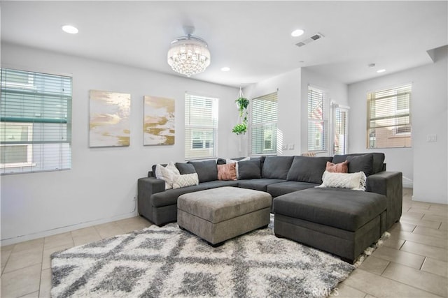 living room with light tile patterned floors and a chandelier