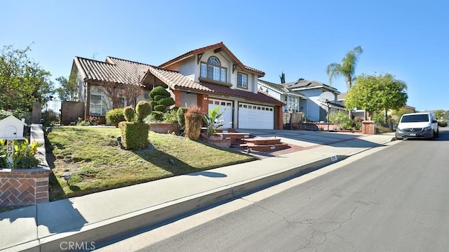 front facade featuring a front yard and a garage