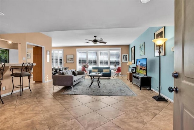 living room featuring ceiling fan and light tile patterned floors