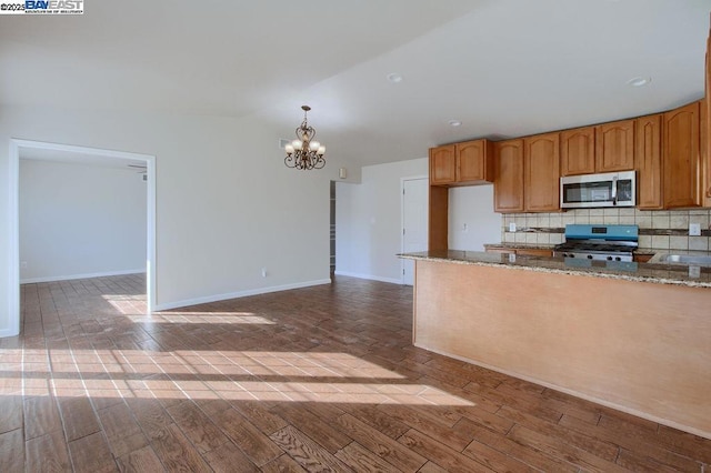 kitchen featuring decorative backsplash, light hardwood / wood-style floors, hanging light fixtures, a notable chandelier, and stove