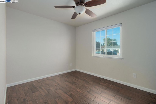 spare room with ceiling fan and dark hardwood / wood-style floors