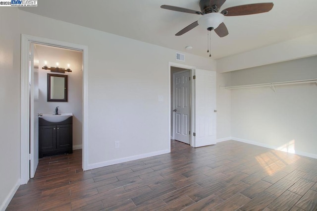 unfurnished bedroom with a closet, sink, connected bathroom, and ceiling fan