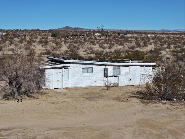 back of house with a mountain view