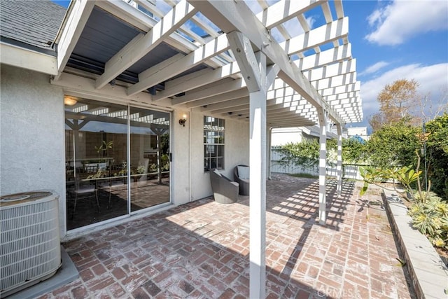 view of patio / terrace with central AC and a pergola