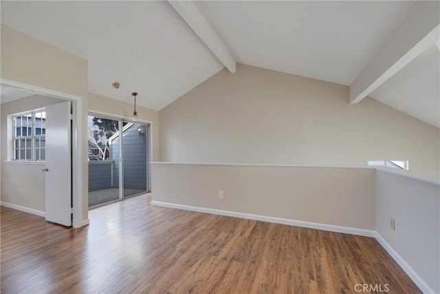 interior space with lofted ceiling with beams and hardwood / wood-style flooring