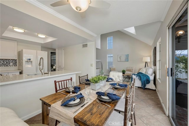 tiled dining space featuring vaulted ceiling and ceiling fan