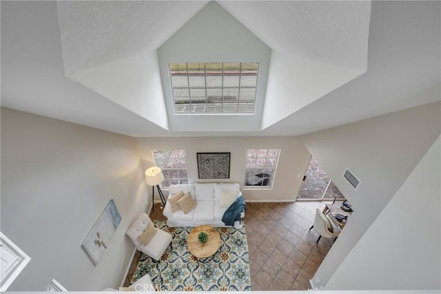 living room featuring tile patterned flooring and a high ceiling