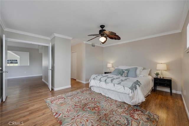 bedroom with ceiling fan, hardwood / wood-style floors, and crown molding