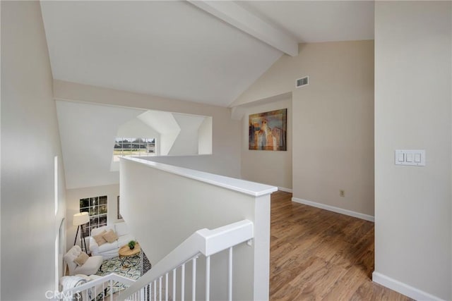 hall with light hardwood / wood-style floors and lofted ceiling with beams