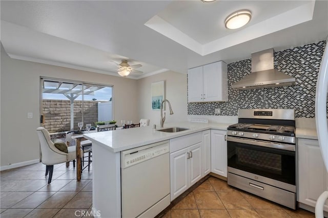 kitchen featuring white cabinetry, wall chimney exhaust hood, dishwasher, and stainless steel range with gas cooktop