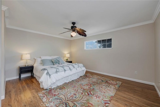 bedroom featuring ceiling fan, crown molding, and hardwood / wood-style flooring