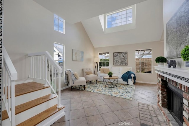 tiled living room with a brick fireplace and high vaulted ceiling