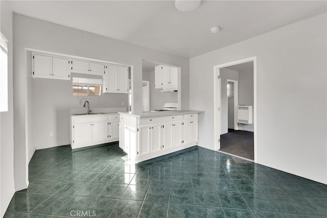 kitchen featuring sink and white cabinets