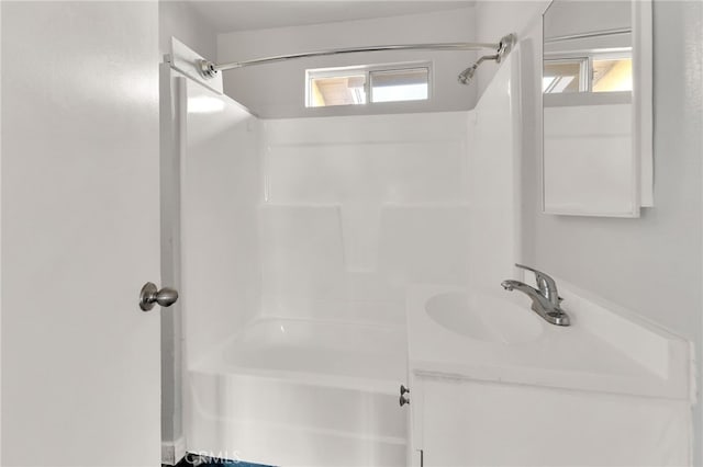 bathroom with tub / shower combination, a wealth of natural light, and vanity