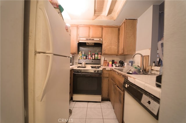 kitchen with tasteful backsplash, sink, white appliances, and light tile patterned floors