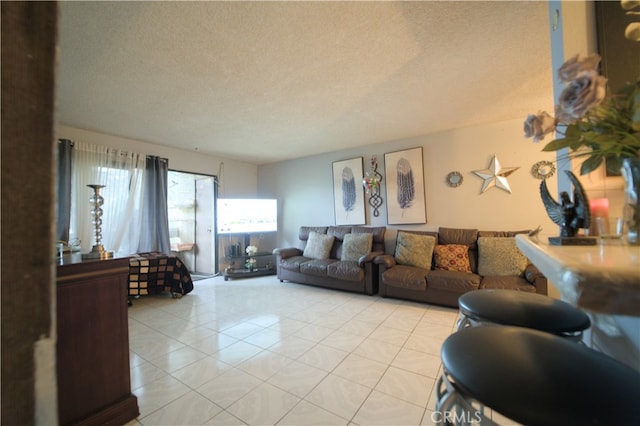 living room featuring light tile patterned floors and a textured ceiling