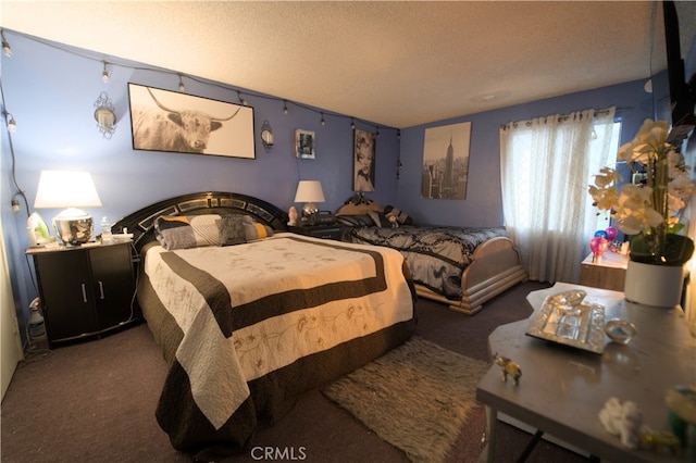 carpeted bedroom featuring a textured ceiling