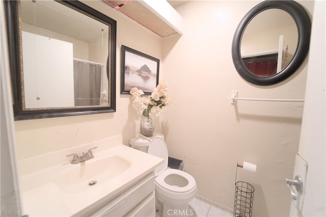 bathroom featuring vanity, toilet, and tile patterned flooring