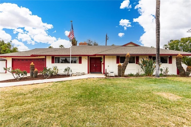 ranch-style house featuring a garage and a front lawn